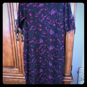 Never worn. Navy blue background with feathers